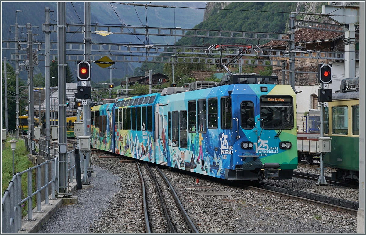 A rather colorful WAB Panoramique train advertises the anniversary 125 WAB. The train arrives at Lauterbrunnen train station.

Aug 8, 2024