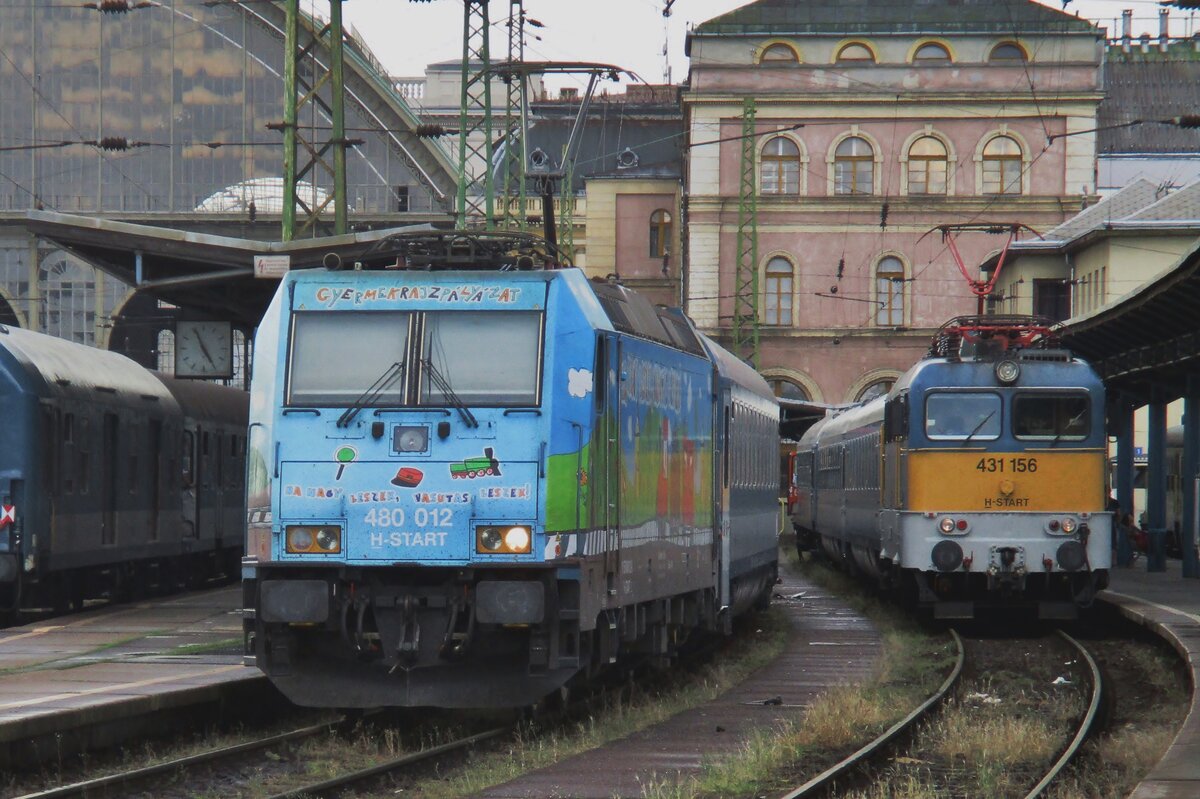 Double trouble? On a rainy 12 May 2018 MAV advertising TRAXX 480 012 and Szili 431 156 stand together at Budapest-Keleti.