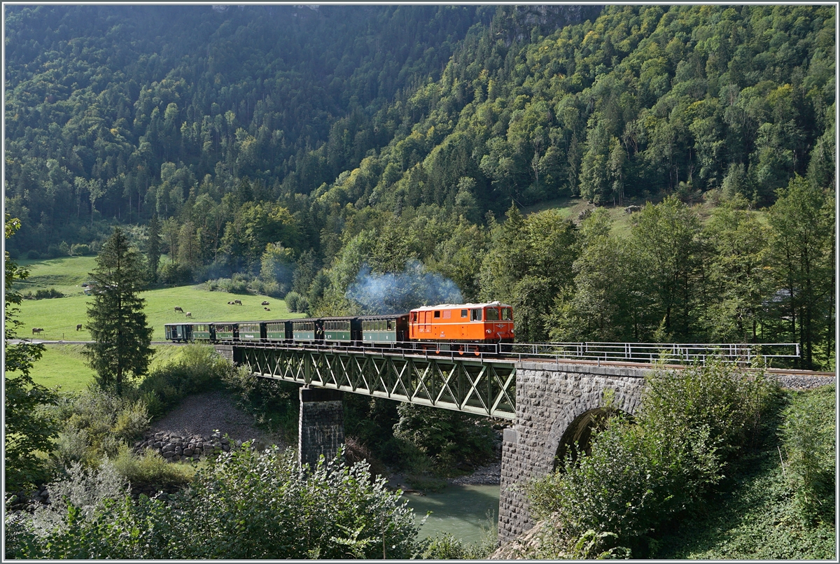 The Bregenzer Wald Bahn (ex) ÖBB 2095.13 is traveling with its morning train from Bezau to Schwarzenberg. Shortly before its destination, the train rolled over the 68 meter long Sporenegg Bridge. 
The bridge leads over the Bregenzer Ach bridges.

September 15, 2024