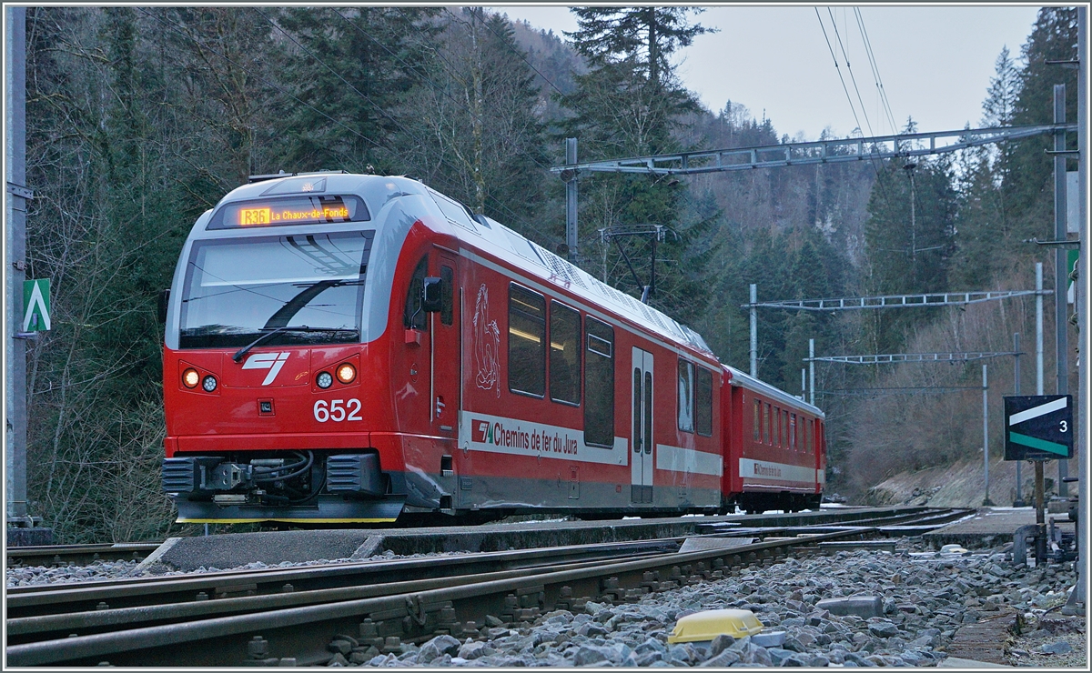 The Combe Tabeillon train station was built at the very back in the deep valley. Here the CJ trains change their direction on the journey from Glovelier to La Chaux de Fonds. Through this hairpin bend, the route gains the necessary altitude on this route. 
In the picture the CJ Be 4/4 with its ABt 712 shortly before continuing its journey. 

Jan 13, 2025