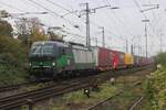 LTE 193 511 hauls an intermodal train to Tilburg-Industrie out of Emmerich station on 23 October 2024.