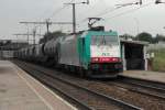 CoBRa 2812 with tank train speeds out of Antwerp and passes the Noorderdokken sttaion on a grey 22 August 2013.