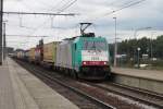 CoBRa 2834 speeds through Antwerpen-Luchtbal on a grey 18 June 2014.