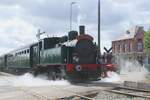 HELENA 2069 leaves Baasrode Noord with a steam shuttle to Puurs on 6 July 2024 during the Scheldeland in Stoom weekend -behind the loco, a steam tractor tries in vain to hide for the photographer.