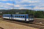 RegioMouse 810 333 stands at Beroun on 10 May 2024 and gets photographed from 'my' train.