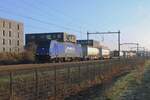 Crossrail 186 269, with Rhenus advertising livery,  hauls a container train through Tilburg-Reeshof on 10 January 2025.