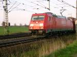 German freight train locomotive class 185 is pulling a long freight train in direction Gro Gleidingen near Brunswick. The picture was taken at the 9th April 2009.