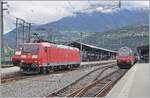 The DB 185 104 7 in the middle of SBB Re 460 locomotives in Brig.