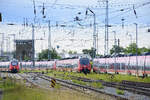 ET 442 819 (left) and ET 442 342 (middle) Talent 2 sets are arranged on depot tracks at Rostock Hauptbahnhof (central station).