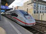 ICE 4 train Tz 9004 as service ICE 707 from Hamburg to Munich is about to depart from Erfurt. A train mural is visible in the background. 2025-02-21