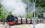 Steam locomotive 99 2322-8 on its way with a long train of carriages to the first stop in Bad Doberan called »Stadtmitte« (downtown). Date: 7th June 2025.

