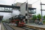 01 202 in Swiss posession, with a steam train to Interlaken ost leaves a rainy Spiez on 14 May 2010.