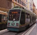 Tram 9018 is coming towards me on a narrow street in Rome. May 7th, 2025