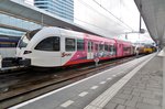 Arriva 262 quits Arnhem Centraal on 27 April 2016, sporting colours advertising the start of the Giro d'Italia in the Dutch province of Gelderland.