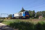 RRF 1103 hauls an empty rake of container wagons through Oisterwijk on 28 June 2019.