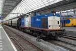 Volker rail 203-1 hauls a set of VSM two-axle coaches through Amsterdam Centraal on 9 July 2018. 