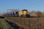 Strukton 303001 'CARIN' hauls a maintenance train through Tilburg-Reeshof on 10 January 2025.