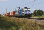 RTB 186 300 'ANTWERPEN' hauls a container train through Hegelsom on 19 August 2024.