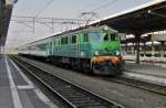 On a grey 5 June 2013 stands PKP EP07-338 with a TKL in Poznan Glowny.