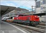 The SBB Aem 940 025 (Aem 91 85 4 940 025-0 CH-SBB I) awaits its onward journey in Lausanne with the mighty Rhomberg Sersa KRC 1200 crane truck (CH RSRM99 85 9219 102-2) and two escort cars (33 85 4505