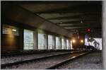 A somewhat daring picture given the lighting conditions: the BLS Re 4/4 191 is waiting in Goppenstein with its (quite short) car tunnel train (AT1) in a structure for the departure to Kandersteg.