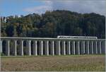 A BLS RABe 528 MIKA is on the way as IR 66 3222 from La Chaux de Fonds to Bern and drives straight to Gümmenen over the striking, 293 meter long Gümmen viaduct.