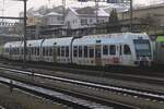 Kamlby advertising EMU 535 114 stands parked at Spiez on 1 January 2025, but will see action in less than ten minutes.