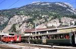 Wagons of Rhaetian railway in green colours and an electric multiple unit of Furka-Oberalp-Bahn (FO) No 45, a BDeh 2/4 at that time, August 23rd, 1979. Before it was a ABDeh 2/4; Foto at Brig.