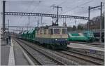 The IRSI Re 4/4 II 11387 (Re 421 387-2) in service by the BAM MBC in Morges with his cargo train from Gland to Apples. In the background are waiting the BAM Ge 4/4 21 and 22. 

04.03.2024