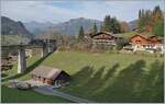 Against the backdrop of pretty chalais near Gstaad, he GoldenPass Express GEX reaches the Grubenbach Bridge.