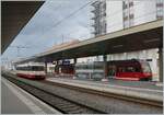 CJ and TransN regional trains are waiting in La Chaux-de-Fonds for their imminent departure.