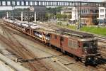 BLS 183 hauls a train of automotives out of Spiez on 5 June 2014.