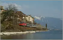 By St Saphorin, on the sea site of the Lake of Geneva runs a SBB Re 460 with his IR to Lausanne.
25.03.2012