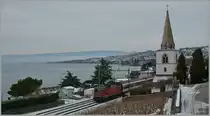 SBB Re 4/4 II 11143 with an IR to Brig by the church of Villette. 
28.12.2010